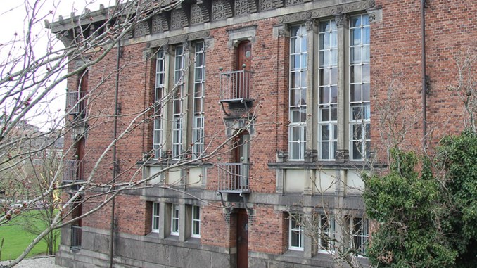 Den røde murstensfacade med høje, småsprossede vinduer i ejendommen til Erhvervsarkivet Aarhus